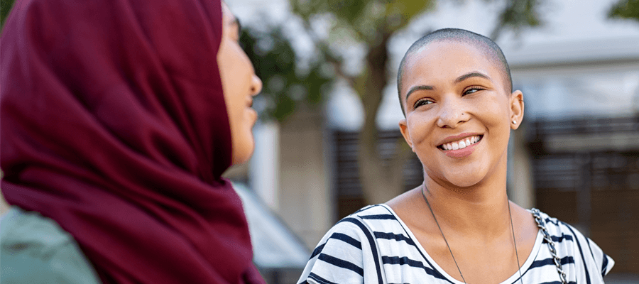 Two women smiling at eachother