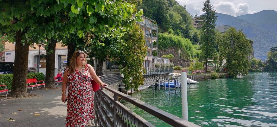 Woman stood beside a lake on holiday