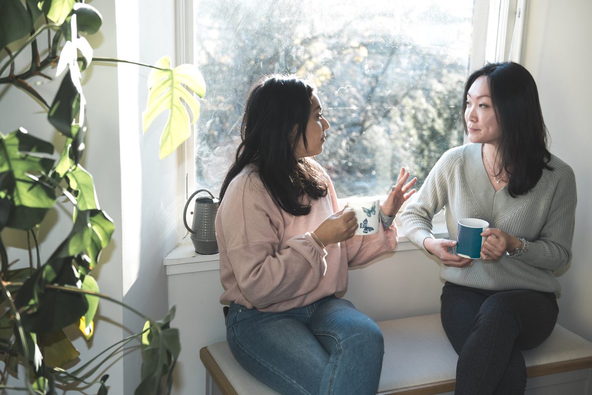 Two women talking and drinking tea